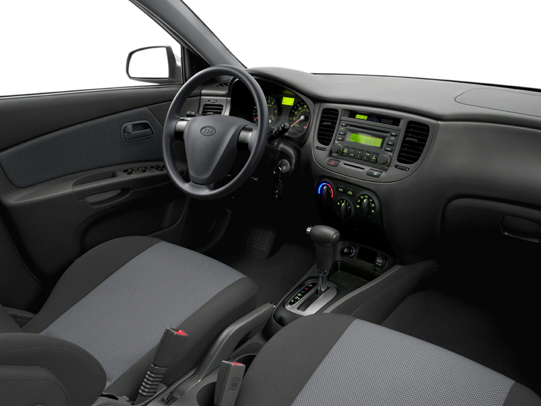 Dashboard, steering wheel, and automatic gear shift in a compact car interior