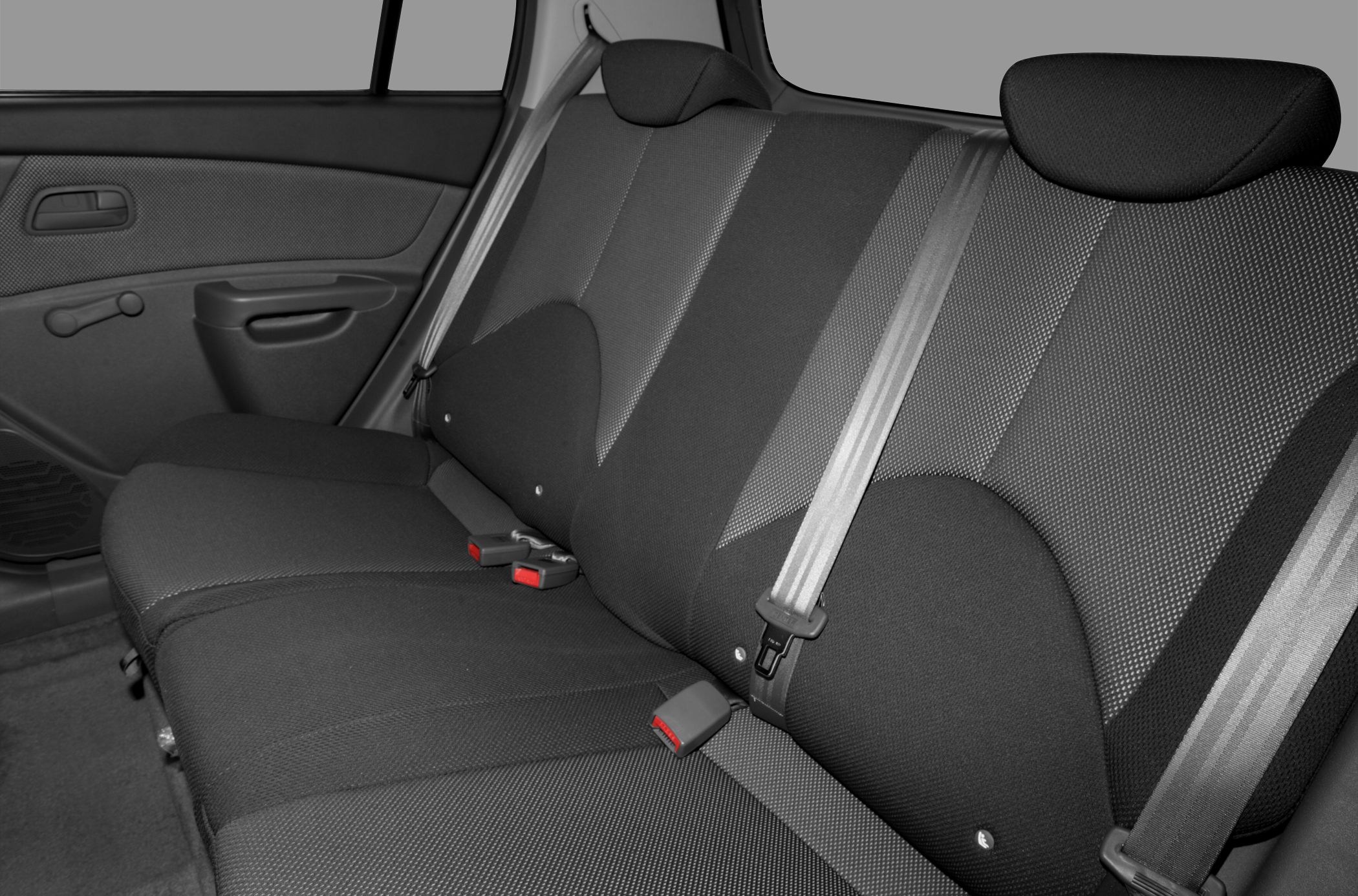 Fabric rear seats with seat belts and door panel featuring window crank