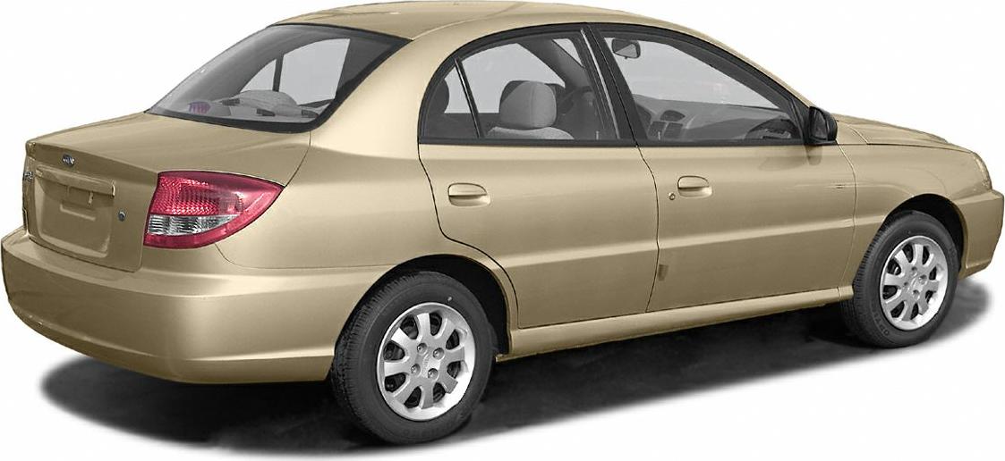 Rear and side profile of a compact beige four-door sedan with rounded tail lights.