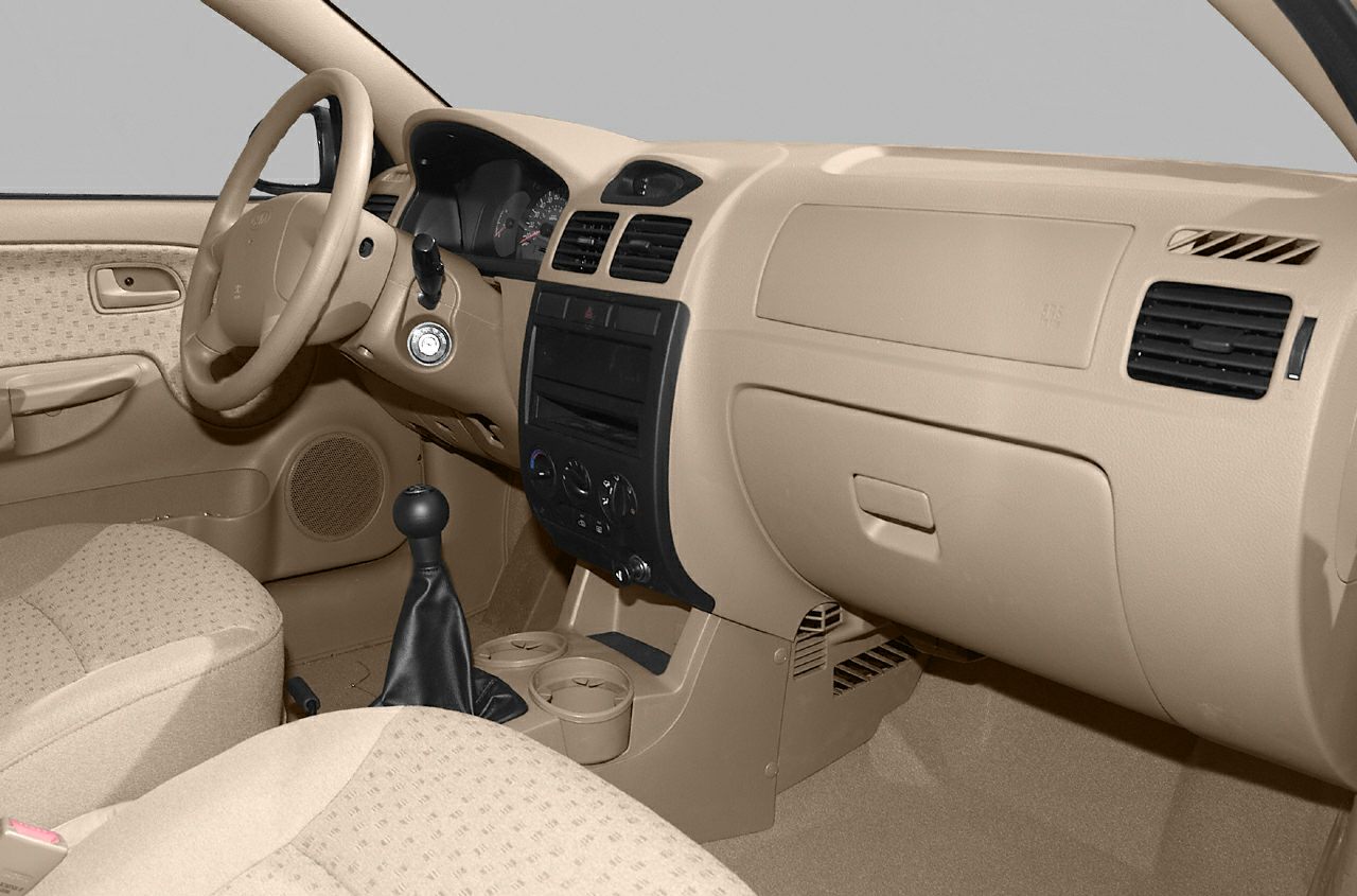 Beige car interior with manual gear stick and basic dashboard design