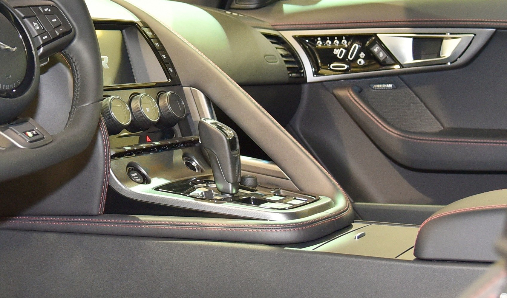 Luxury car interior featuring gear shift and climate controls