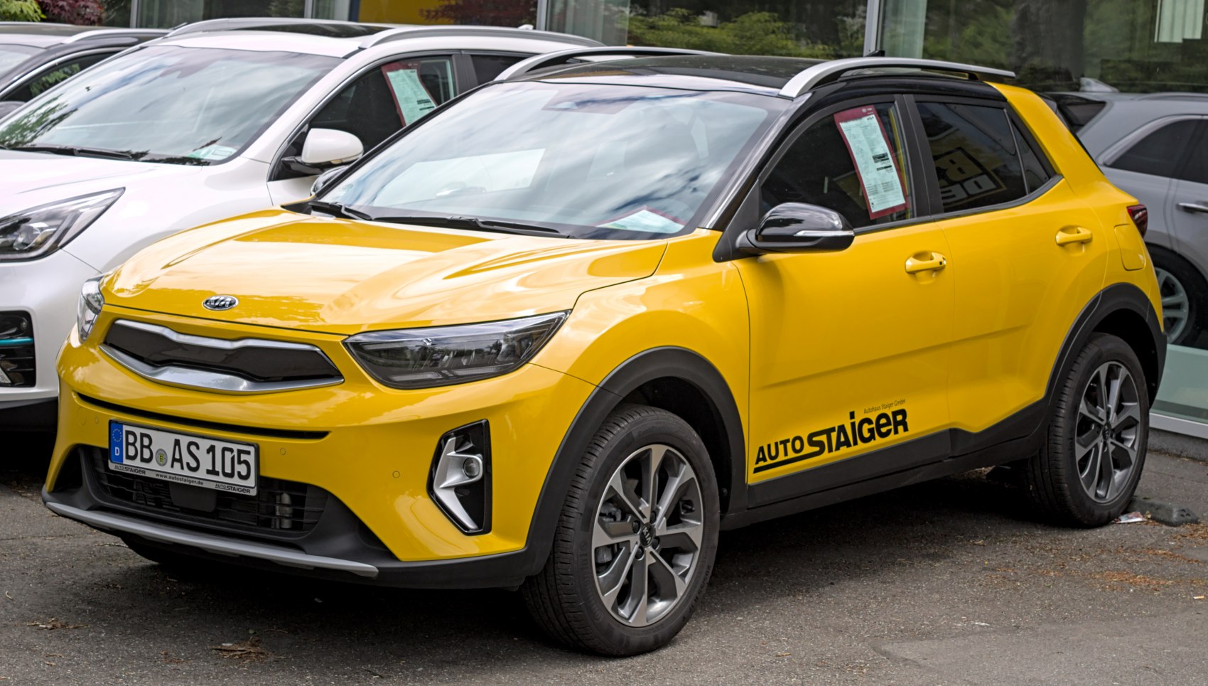 Yellow compact SUV with black roof, modern front, and alloy wheels
