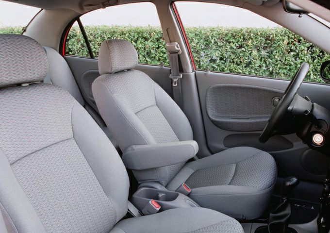 Fabric front seats with center armrest and door panel in compact sedan