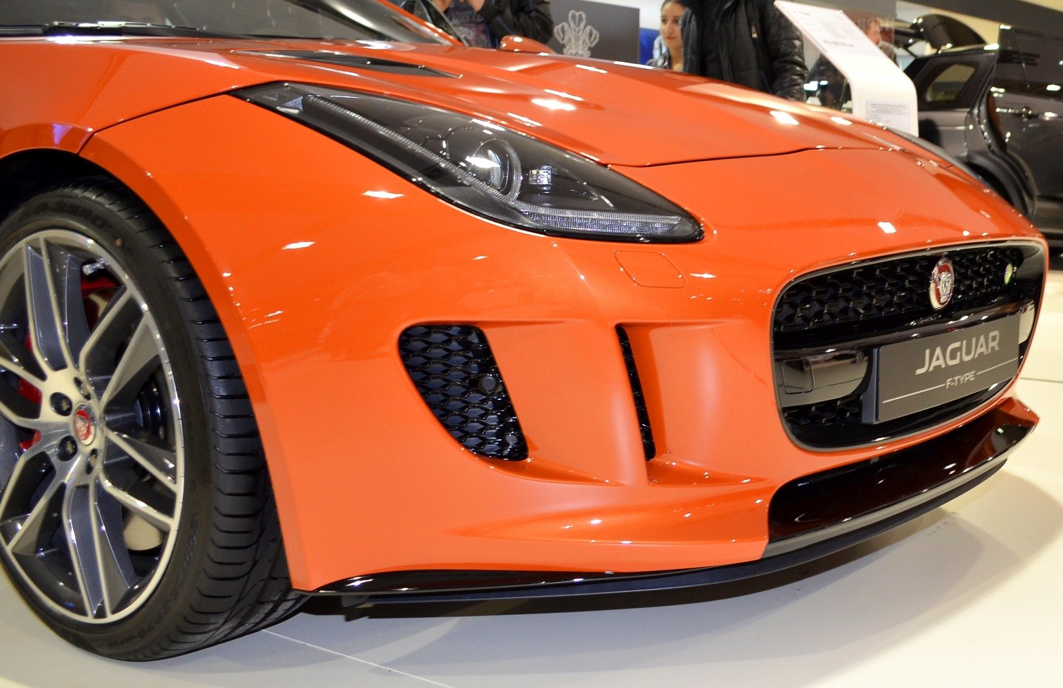 Close-up of car front with headlight and alloy wheel