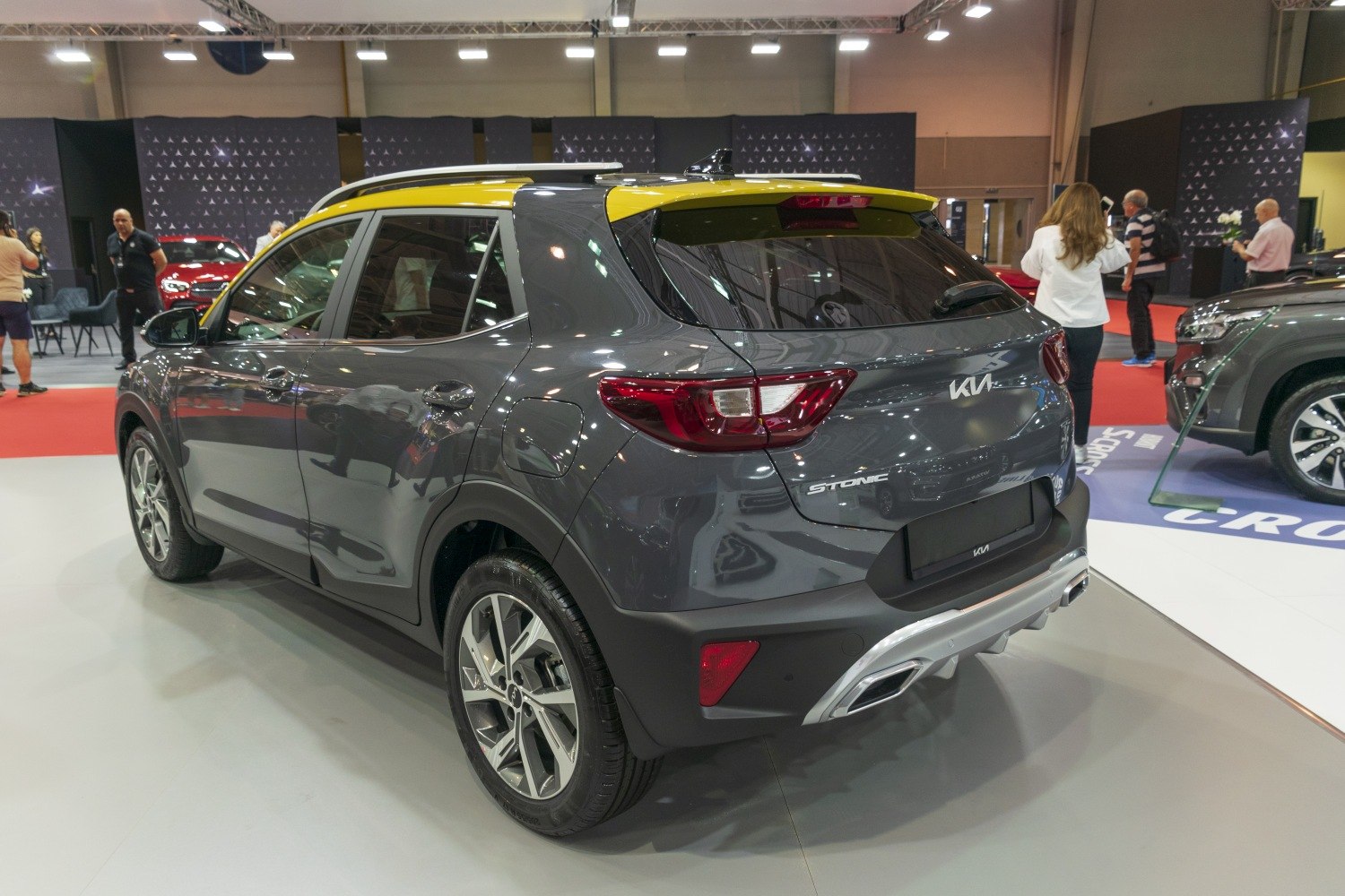 Rear and side view of a gray crossover with yellow roof and alloy wheels