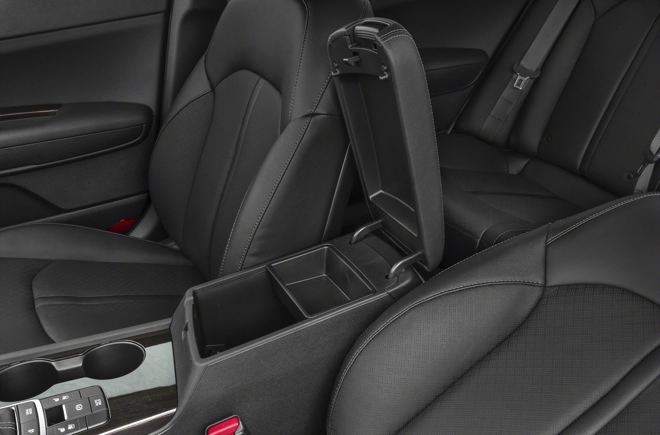Open center console storage between black leather front seats