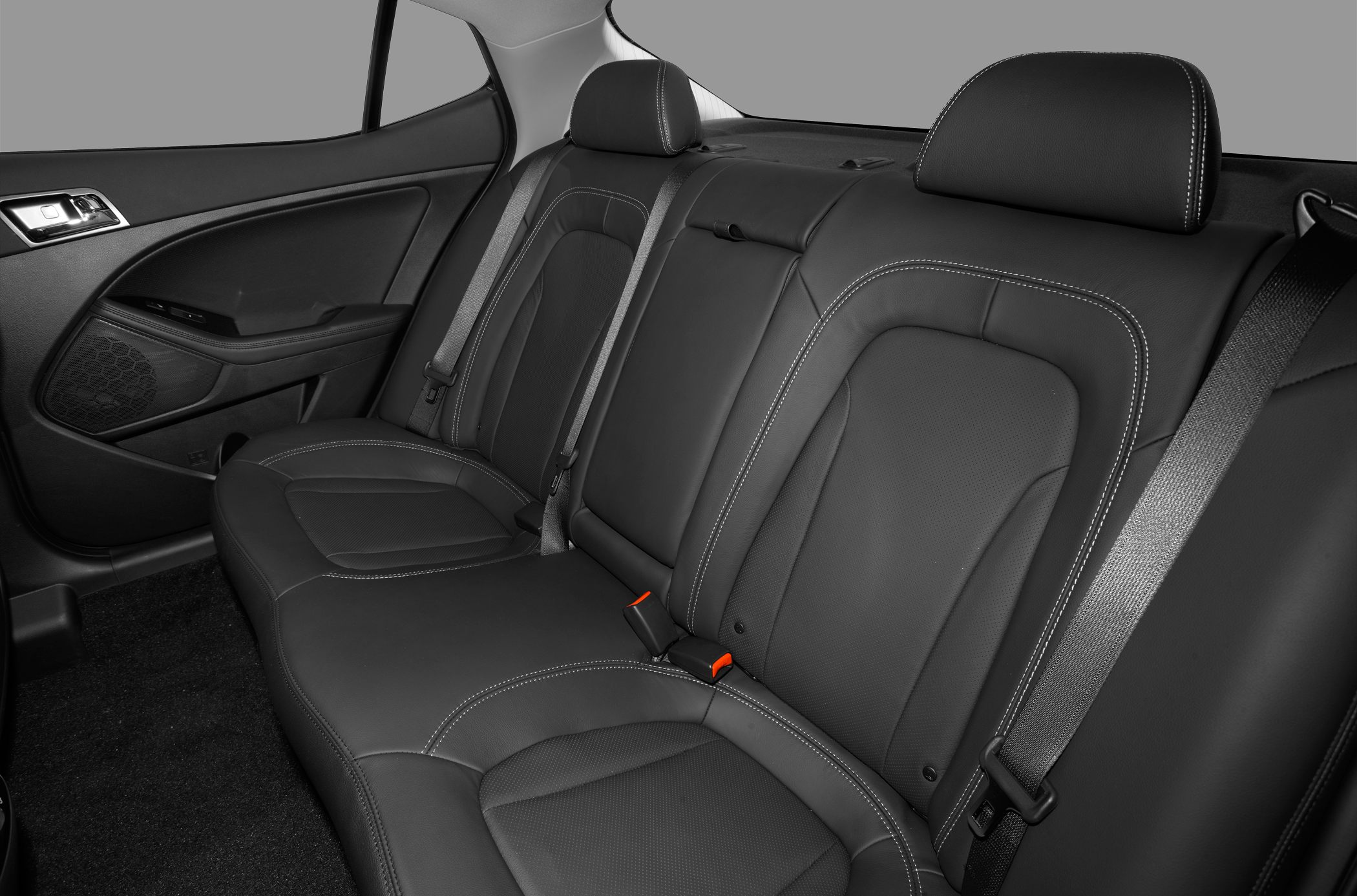 Black leather rear seats with stitching and seatbelts