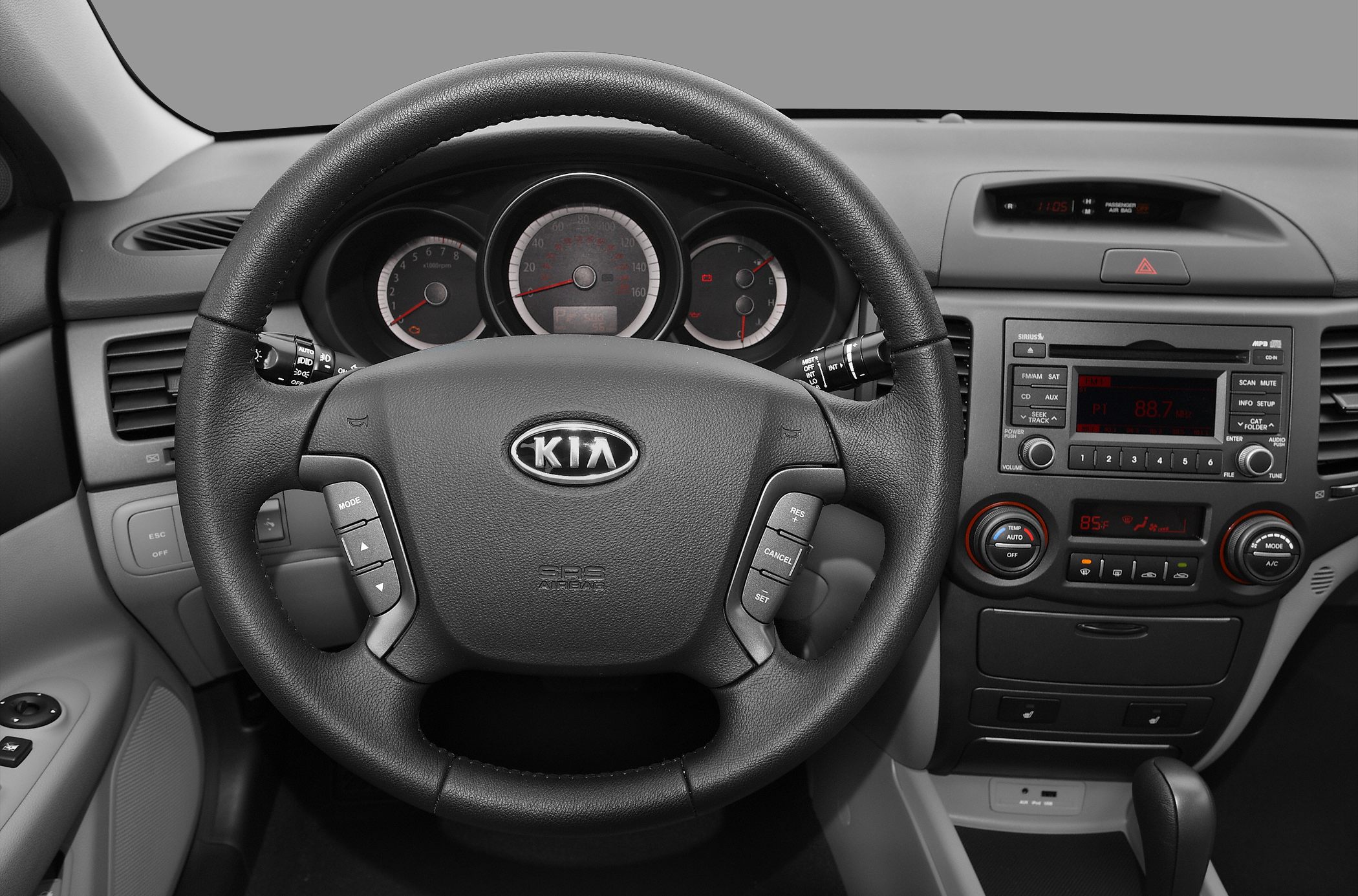 Leather steering wheel with control buttons and detailed instrument cluster