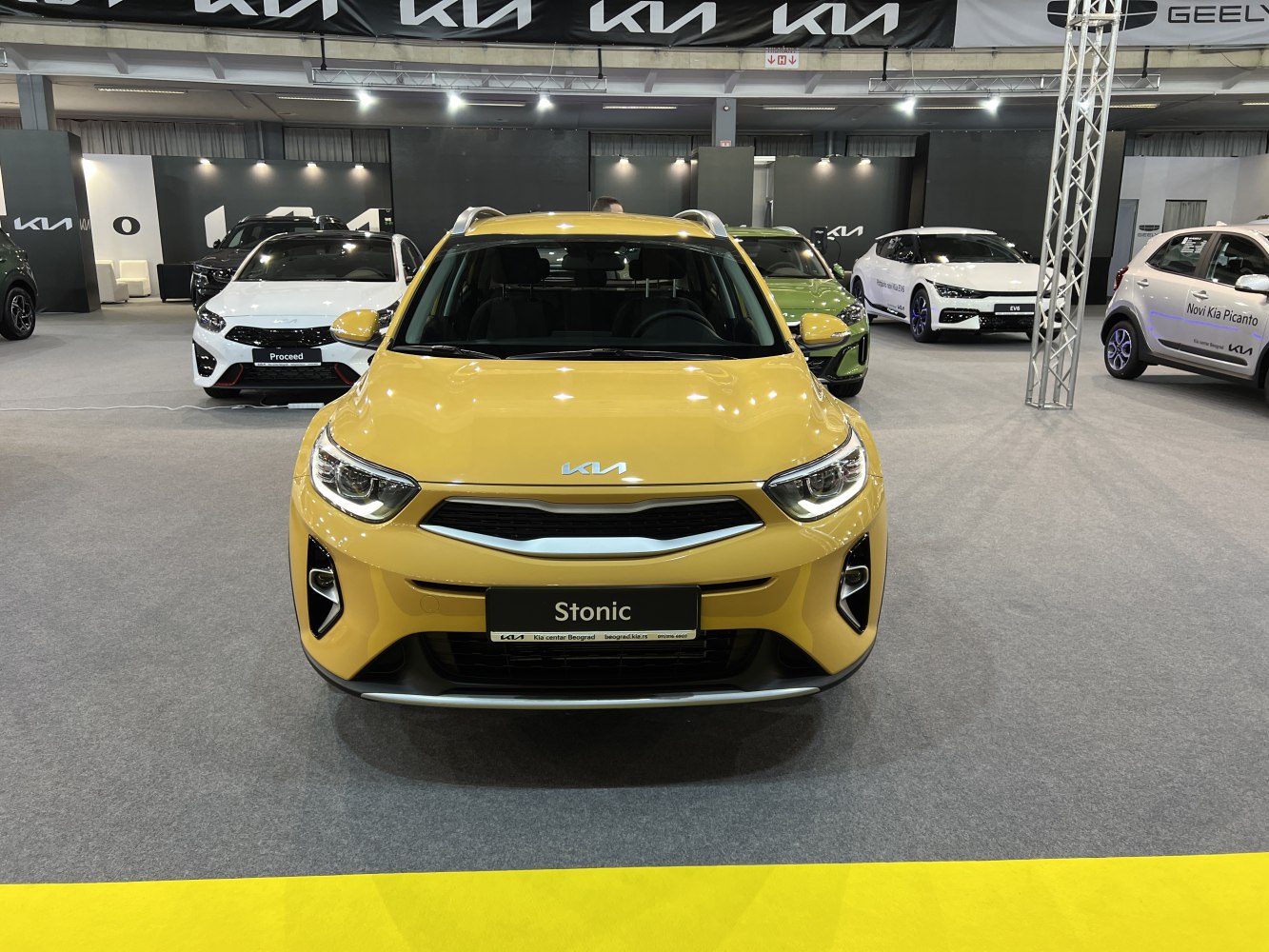 Front view with crossbar grille and sharp headlights, yellow compact SUV.