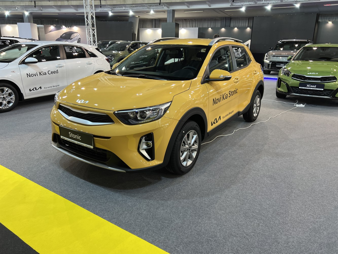 Yellow Kia Stonic facelift with front grille and side profile