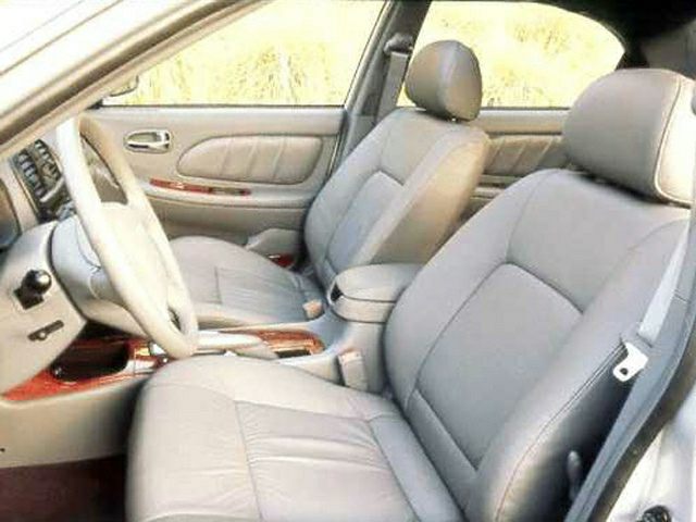 Beige leather front seats and dashboard interior.
