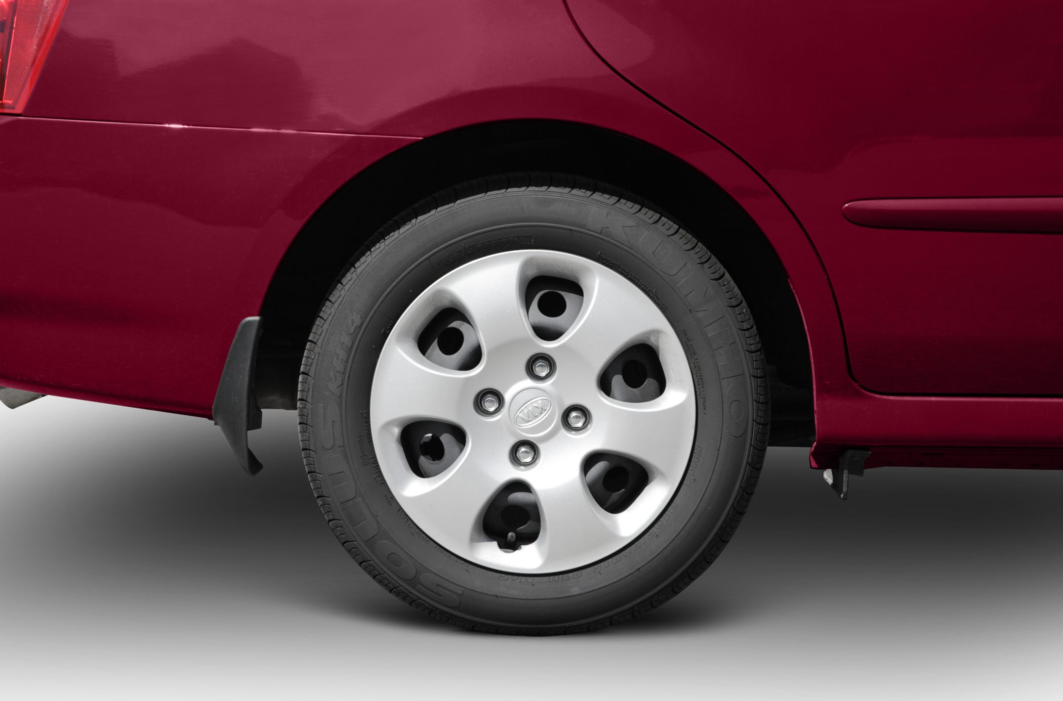 Rear wheel and tire close-up with silver wheel cover and visible tire tread