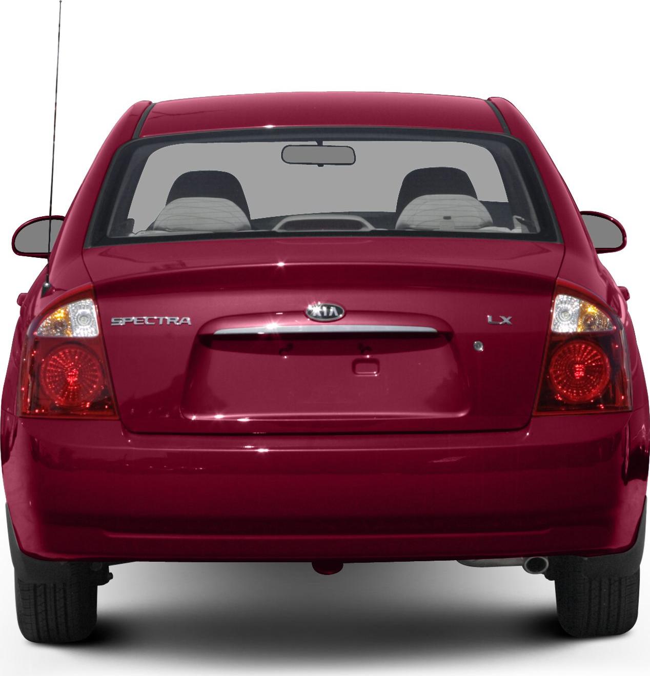 Rear view of a red sedan with taillights, rear windshield, and badges