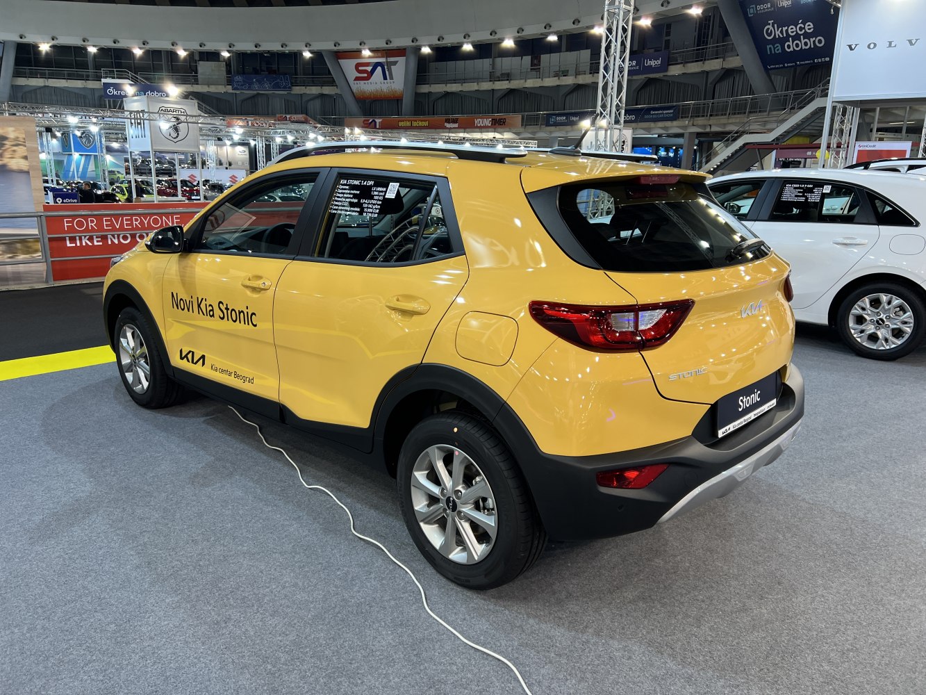 Rear and side view of yellow compact SUV with modern taillights and black lower trim