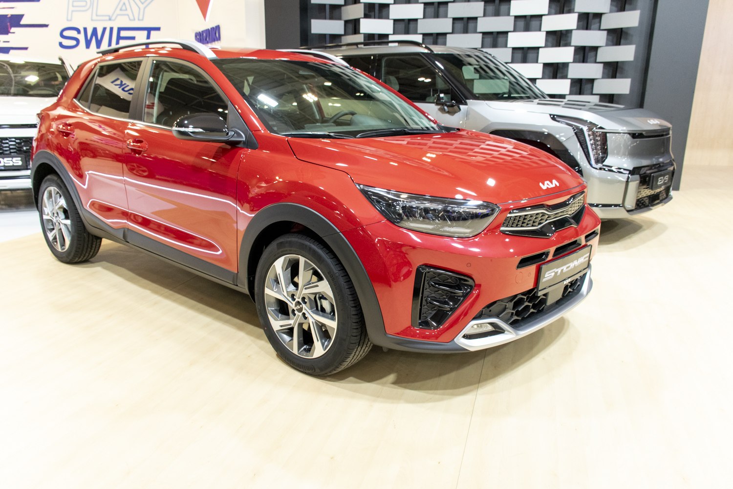 Front-side view of red crossover with LED headlights and alloy wheels