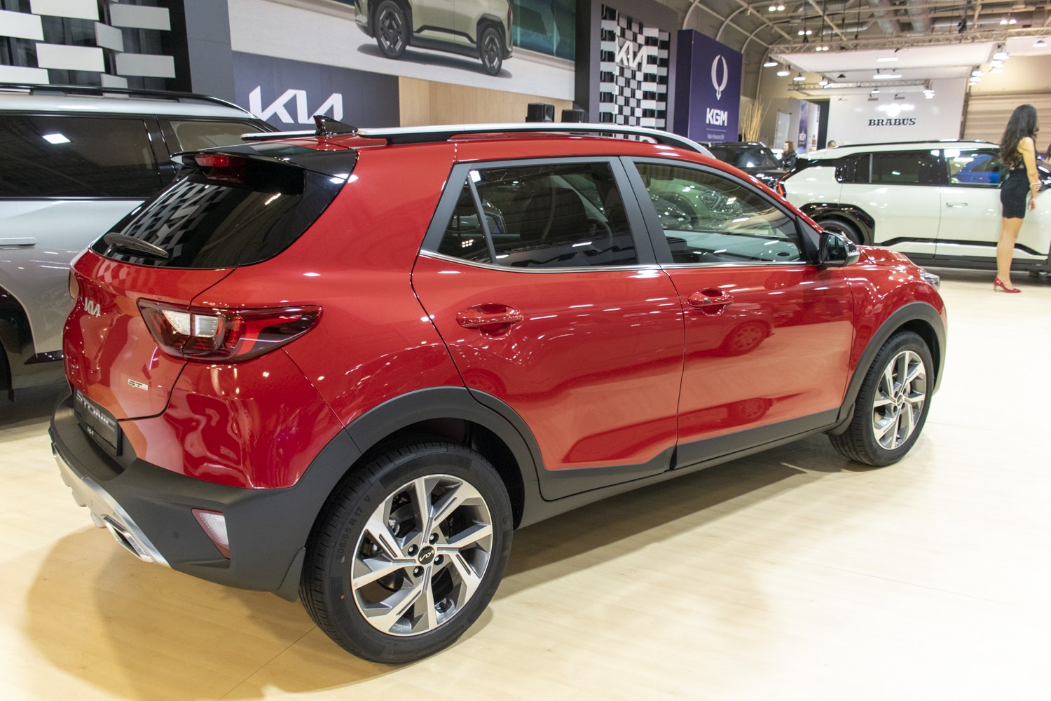 Rear and side profile of red compact SUV with alloy wheels and roof rails