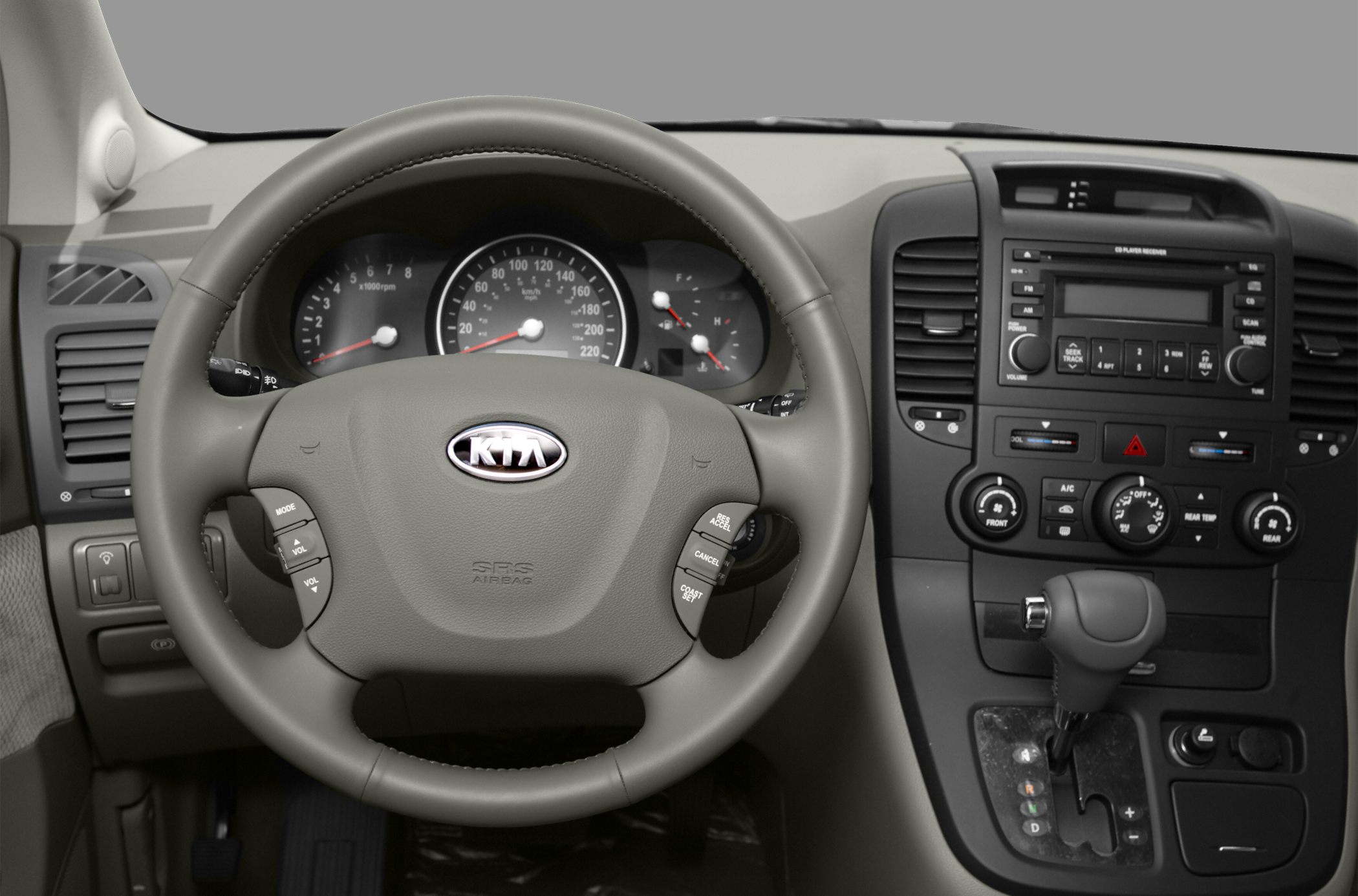 Steering wheel with controls and dashboard including gauges and center console.