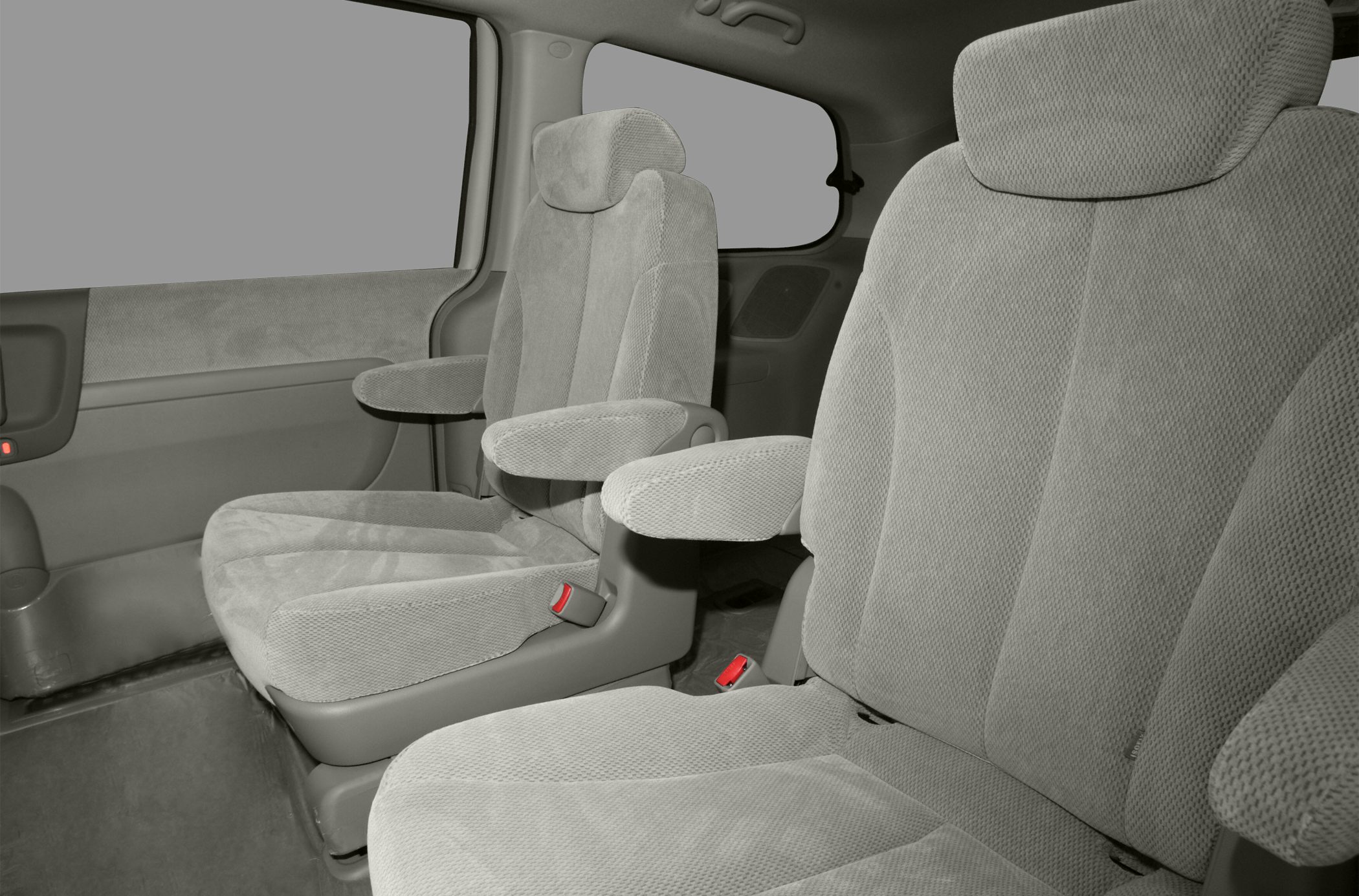 Plush fabric seats with foldable armrests inside a vehicle