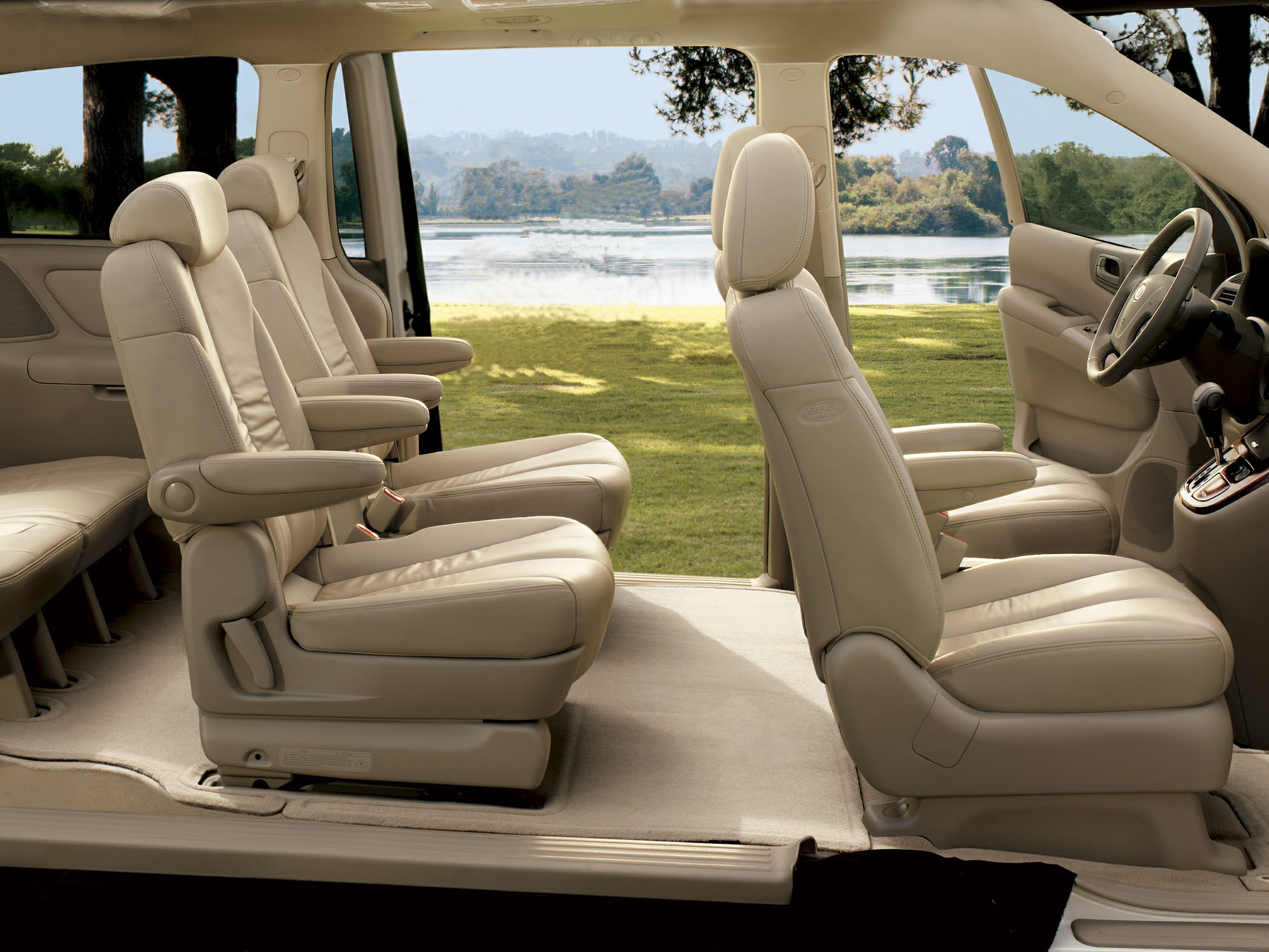 Spacious beige leather captain seats in minivan interior