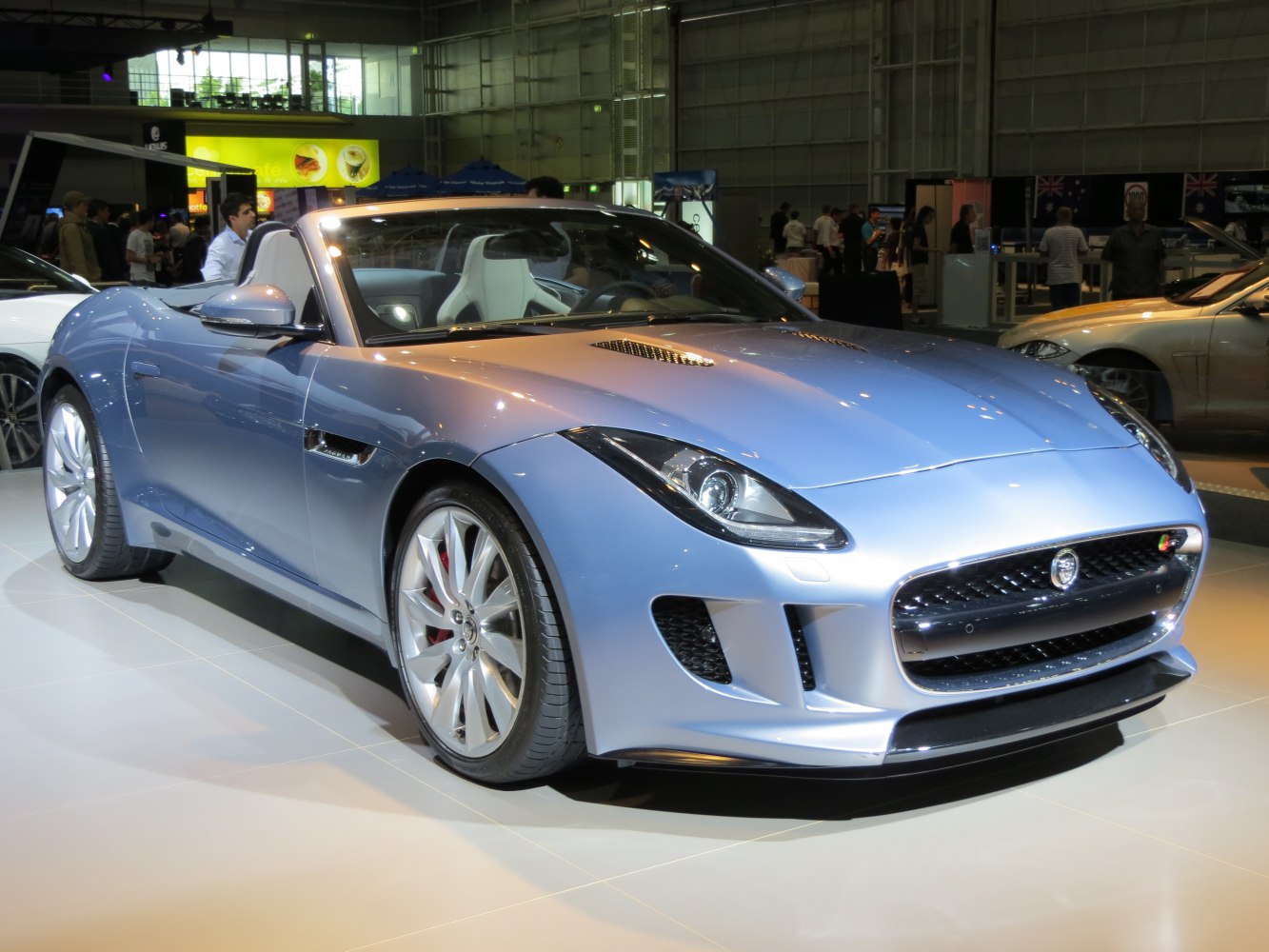 Aerodynamic sleek convertible sports car front side with grille and headlight details.