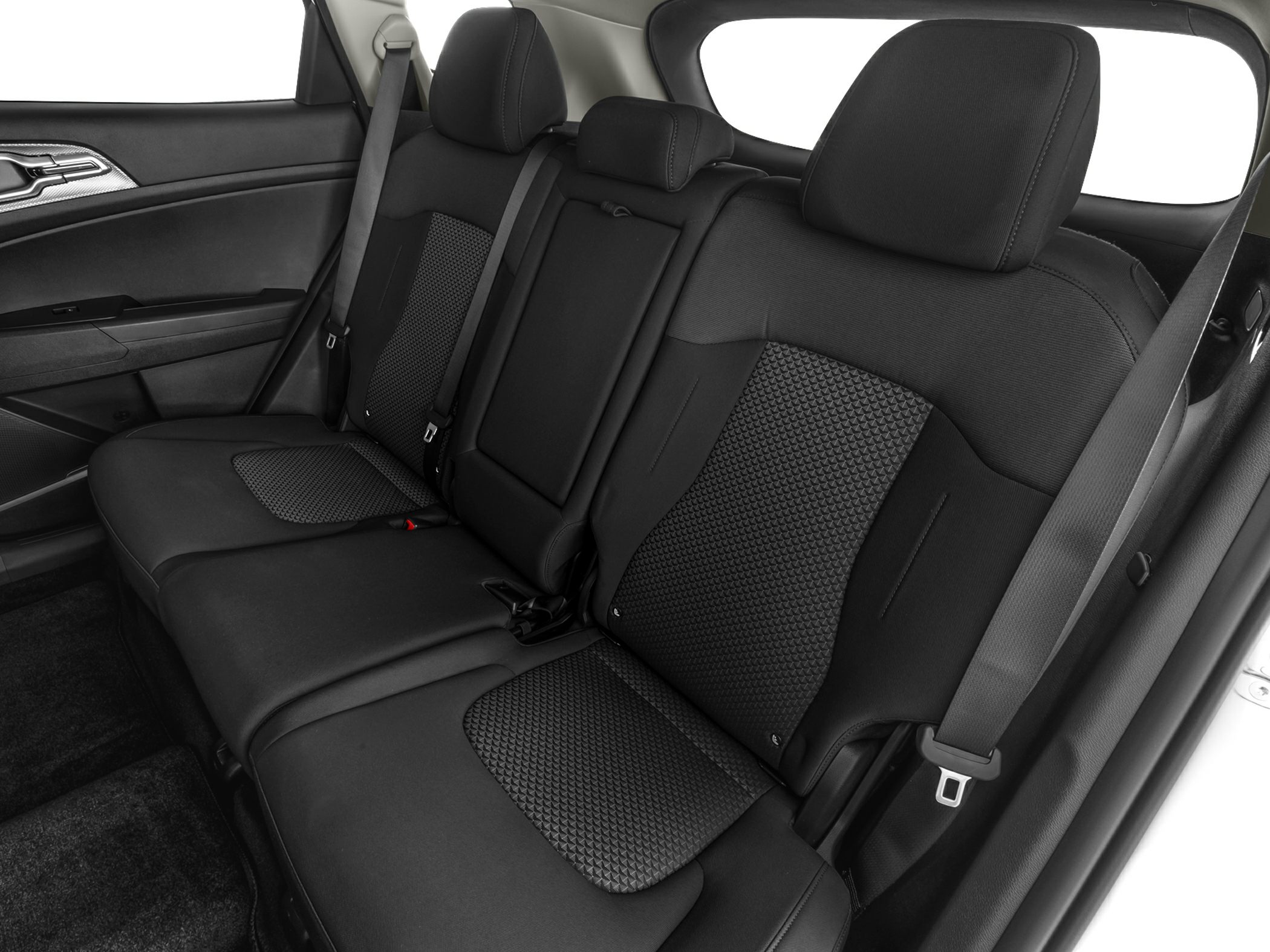 Modern spacious rear seating with patterned upholstery and seat belts.