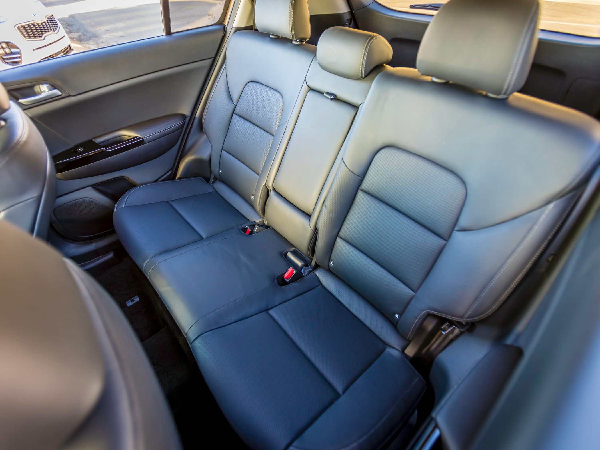 Rear leather seats with headrests and seat belts in SUV interior