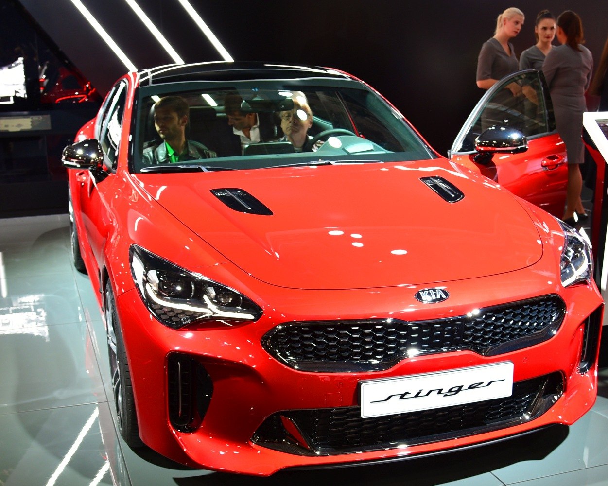 Front view with LED headlights and hood vents in red.