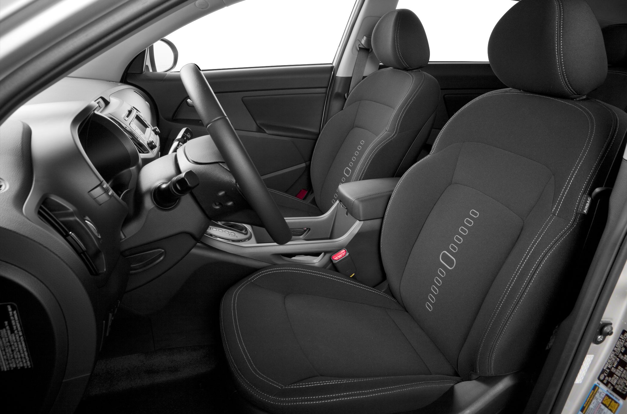 Front seats and dashboard with steering wheel in modern fabric upholstery