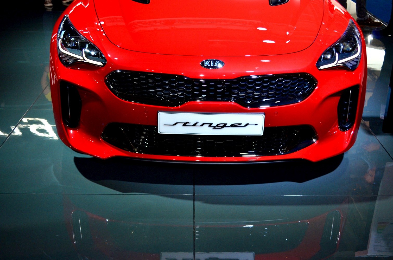 Close-up of sleek LED headlights and honeycomb grille.