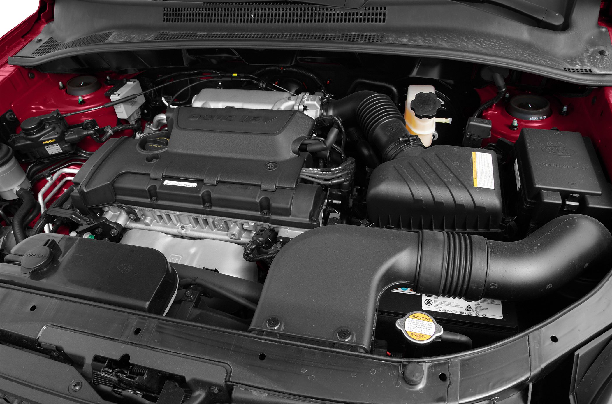 Engine bay with intake, cover, and fluid reservoirs