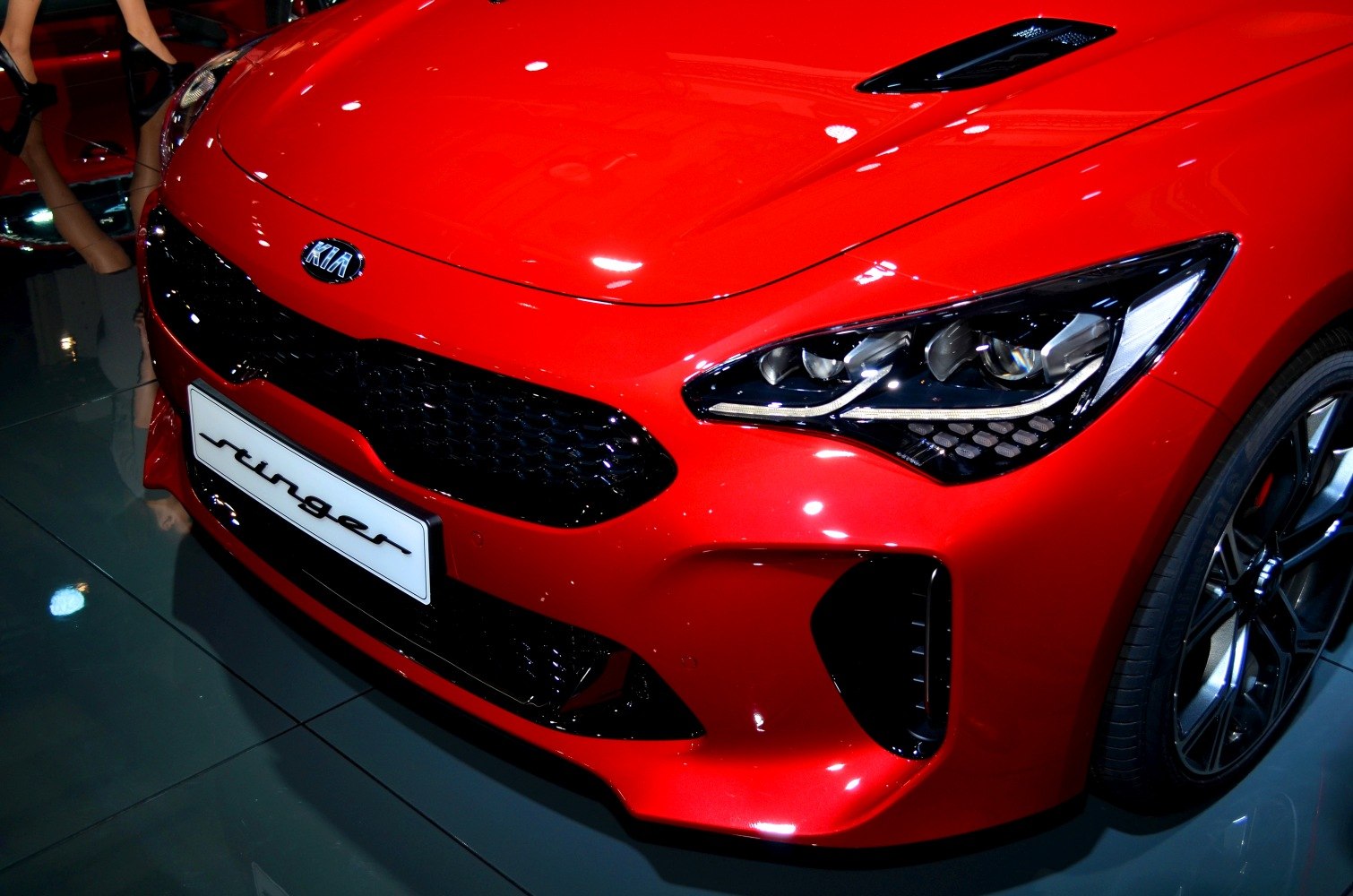 Close-up of sporty front grille and headlight with hood vent