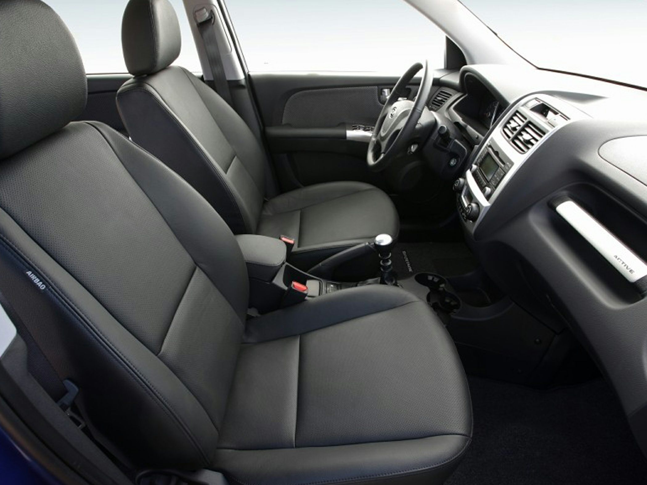 Front seats and dashboard with steering wheel and center console