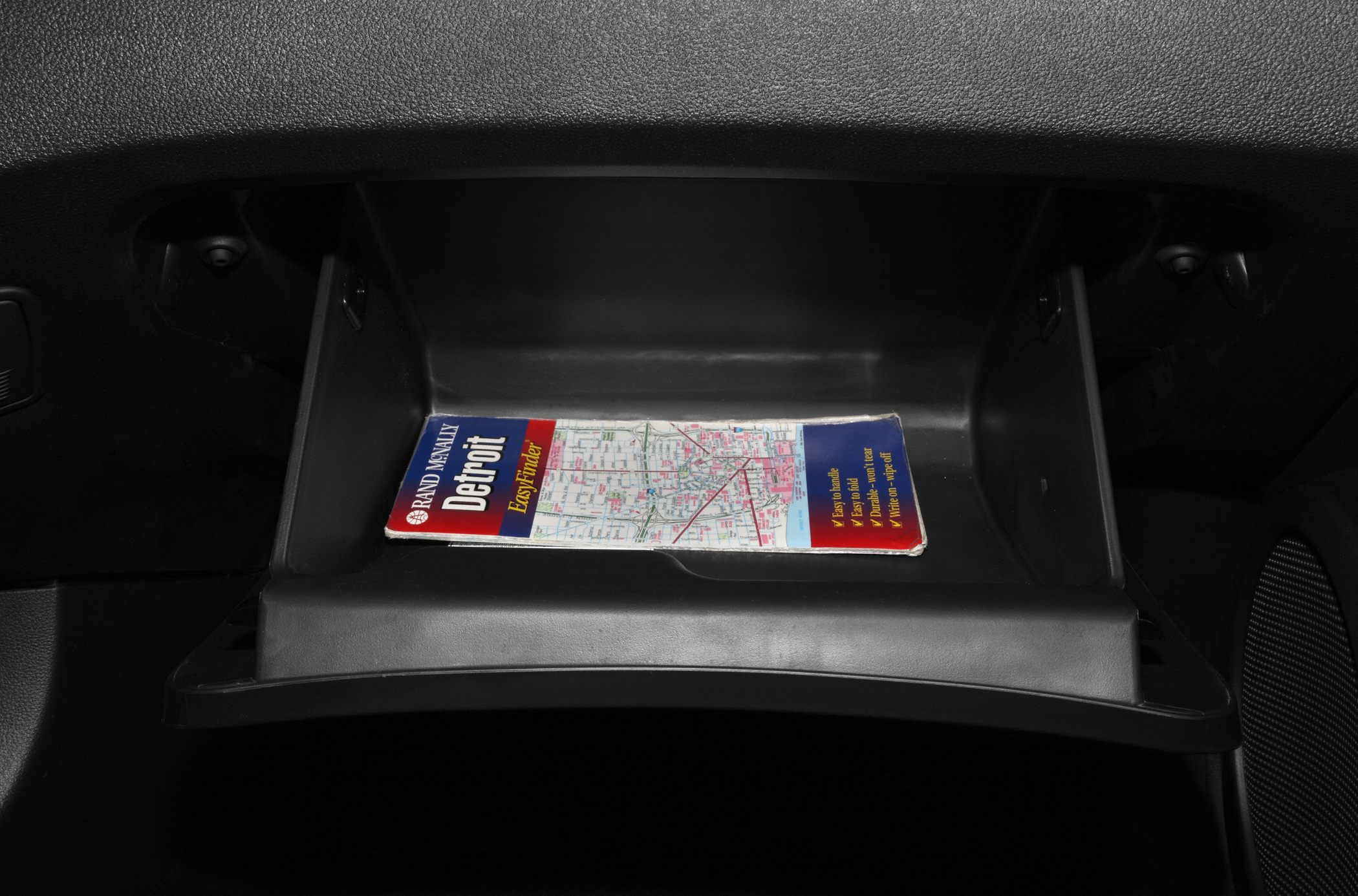 Open glove compartment with map inside