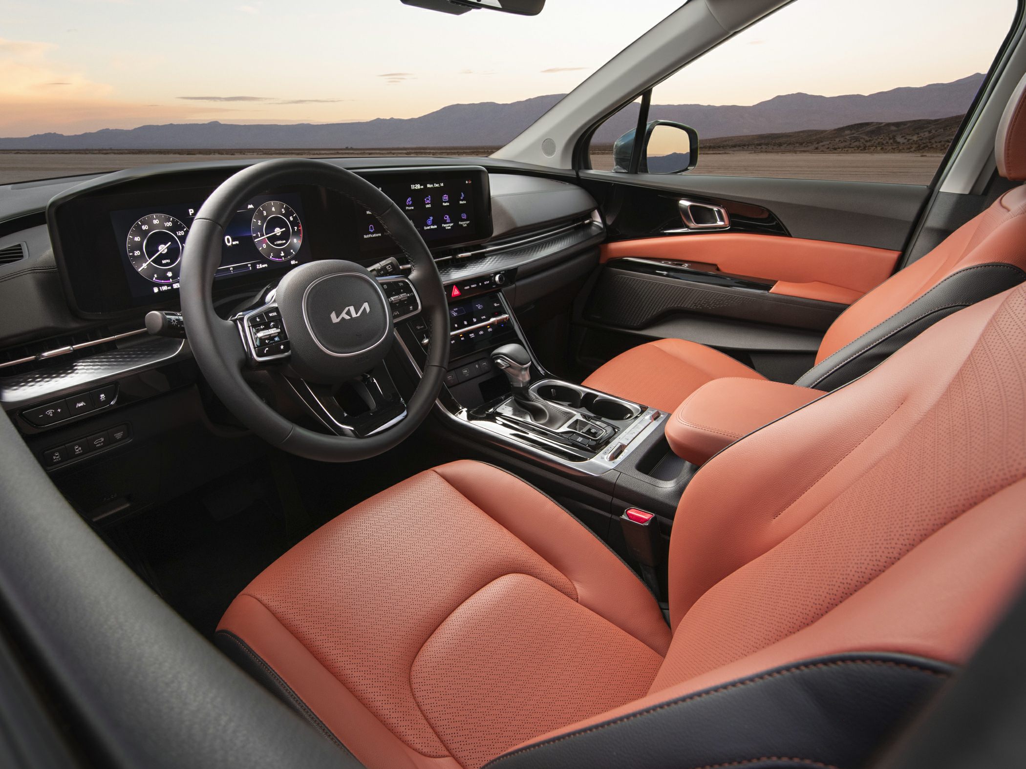 Digital dashboard and orange leather seats in a luxury vehicle interior