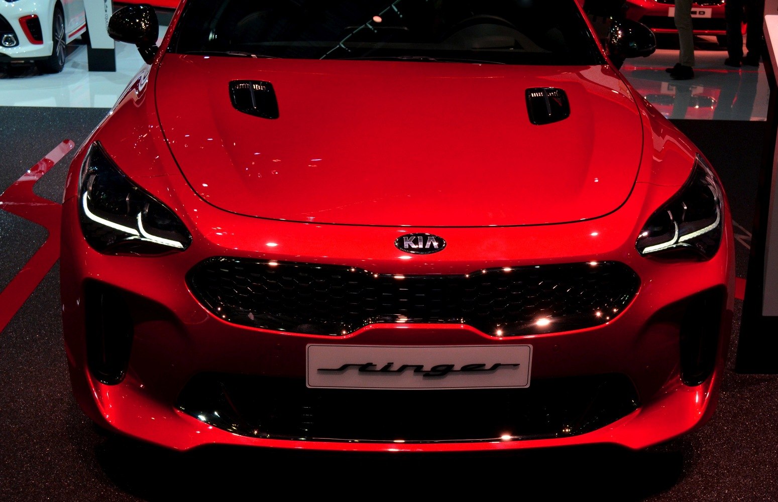 Front view with distinctive headlights and hood vents