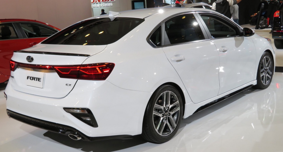 White sedan rear side view with sporty taillights and alloy wheels