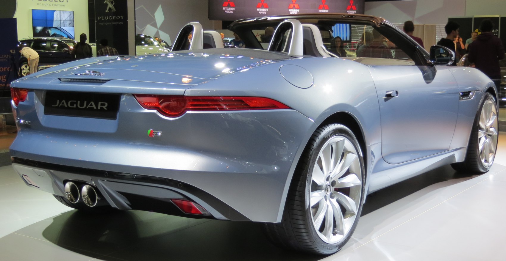 Rear and side view of silver convertible with LED taillights and dual exhaust