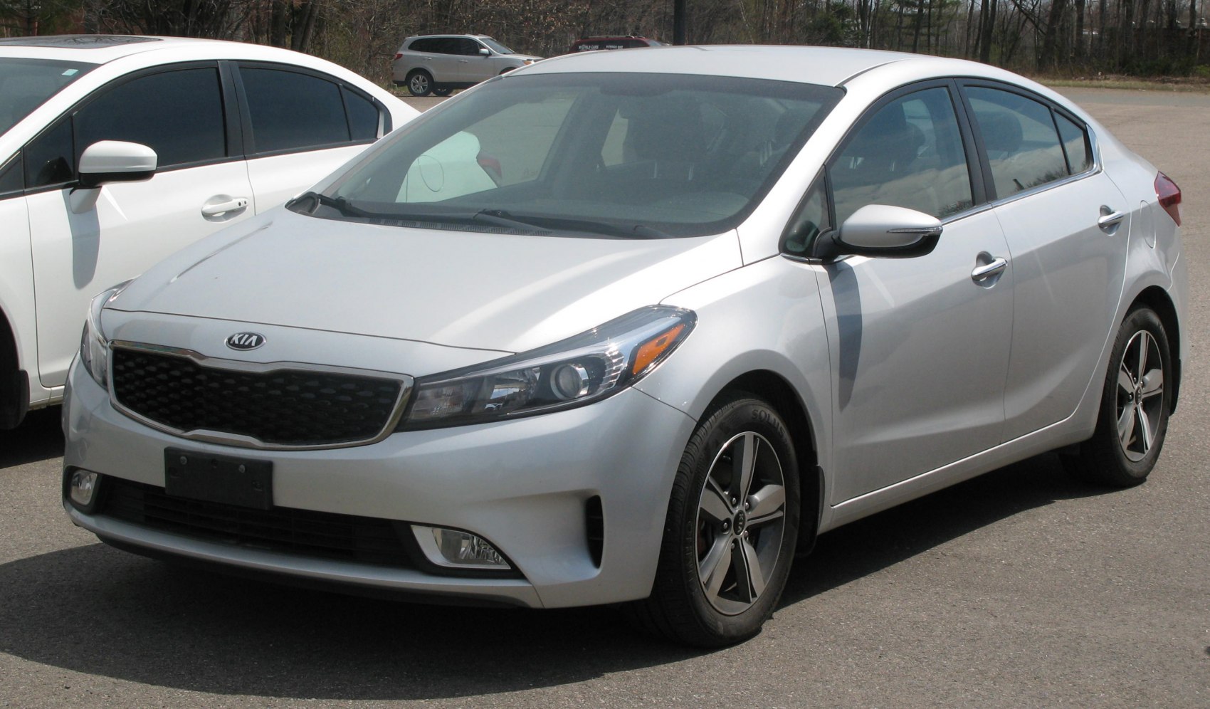 Silver compact sedan with sleek modern headlights and alloy wheels.