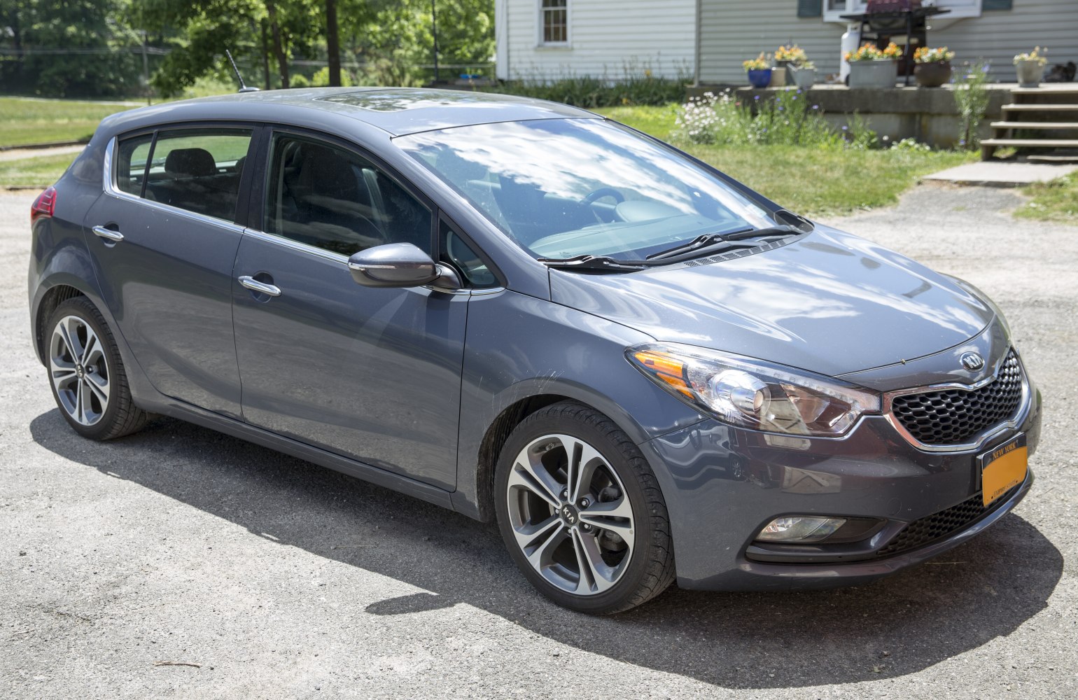 Front-side view of a compact hatchback with alloy wheels and sleek headlights