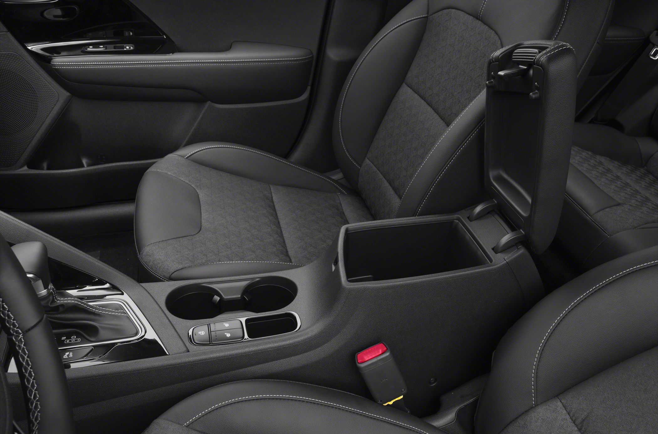 Interior center console with storage, cup holders, gear shifter, and front seat upholstery