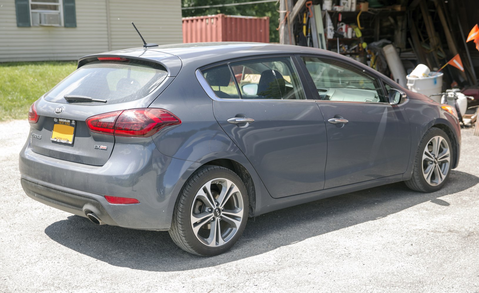 Rear side view of a compact 5-door hatchback with distinct alloy wheels and rear lights