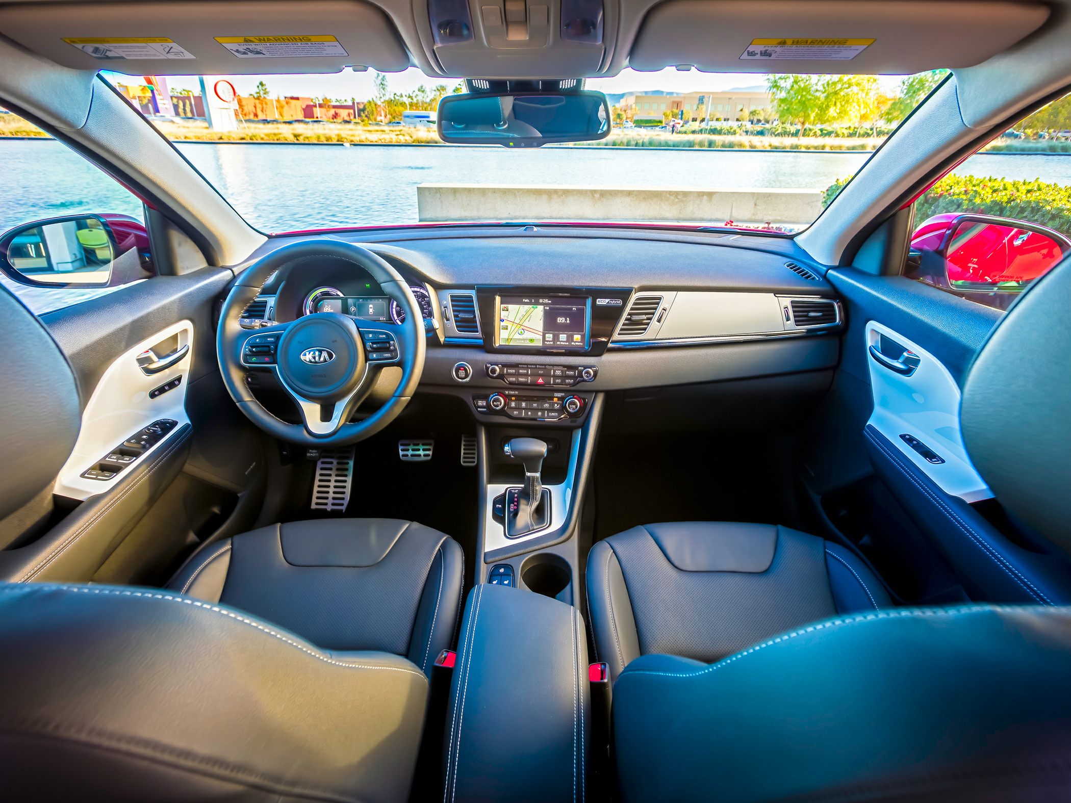 View of dashboard, steering wheel, center console, and seats in car interior