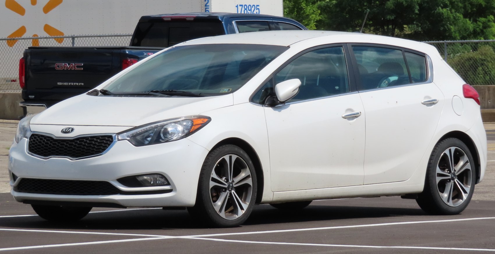 White compact hatchback front-side exterior with alloy wheels