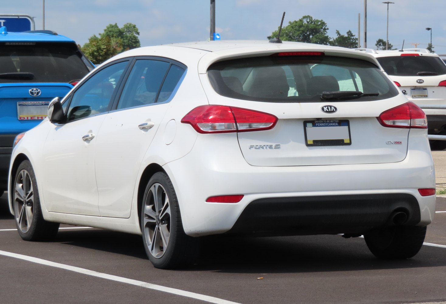 Rear view of white hatchback with alloy wheels and modern taillights