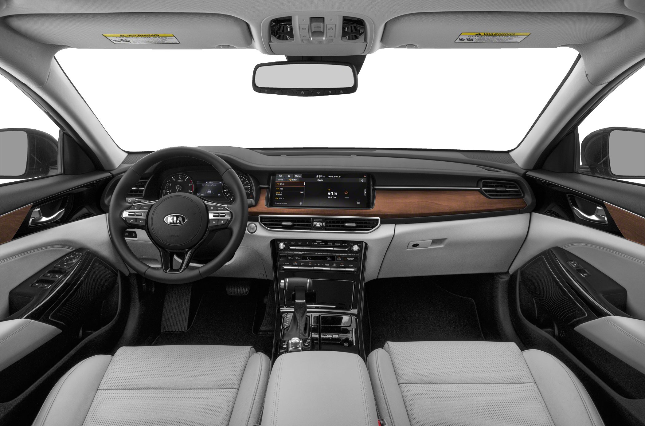 Modern car interior with dashboard, steering wheel, and wood trim