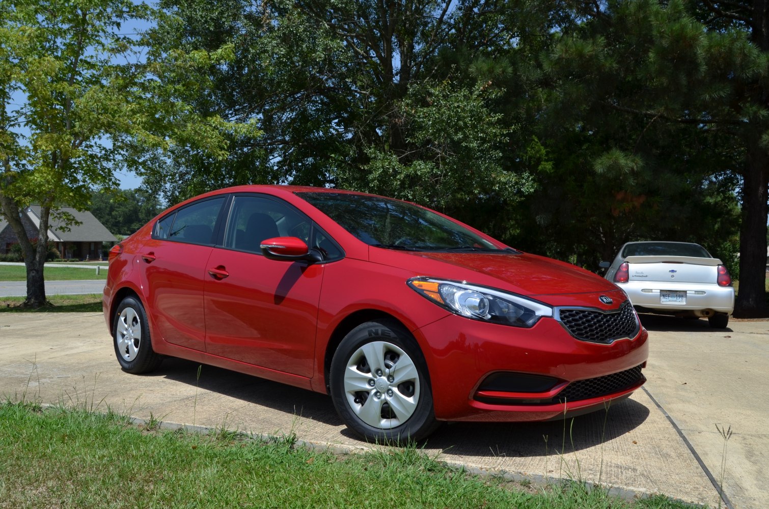 Red sedan with sporty grille and sharp headlights
