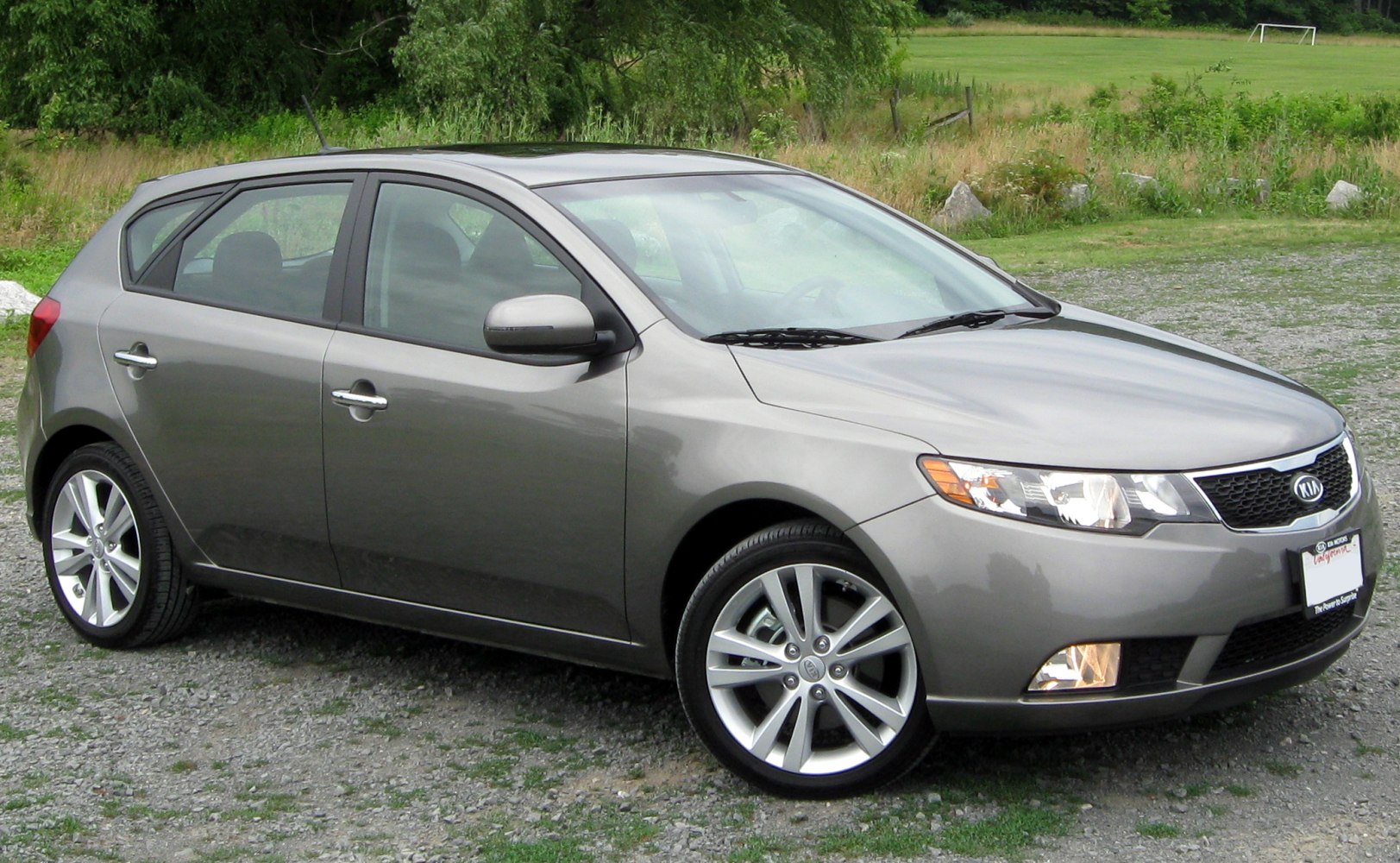 Gray hatchback with alloy wheels and clear headlights