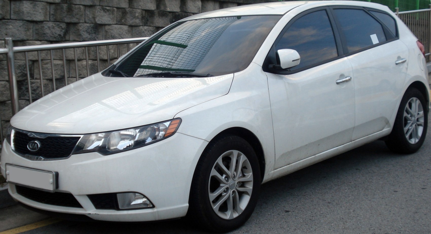 White hatchback with alloy wheels and distinct front grille