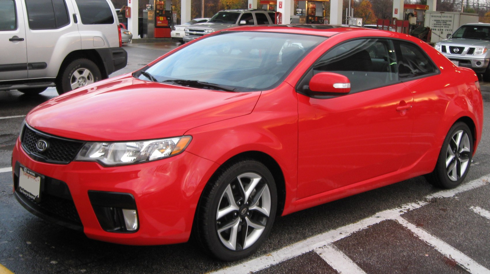 Red sporty coupe with sleek body and alloy wheels