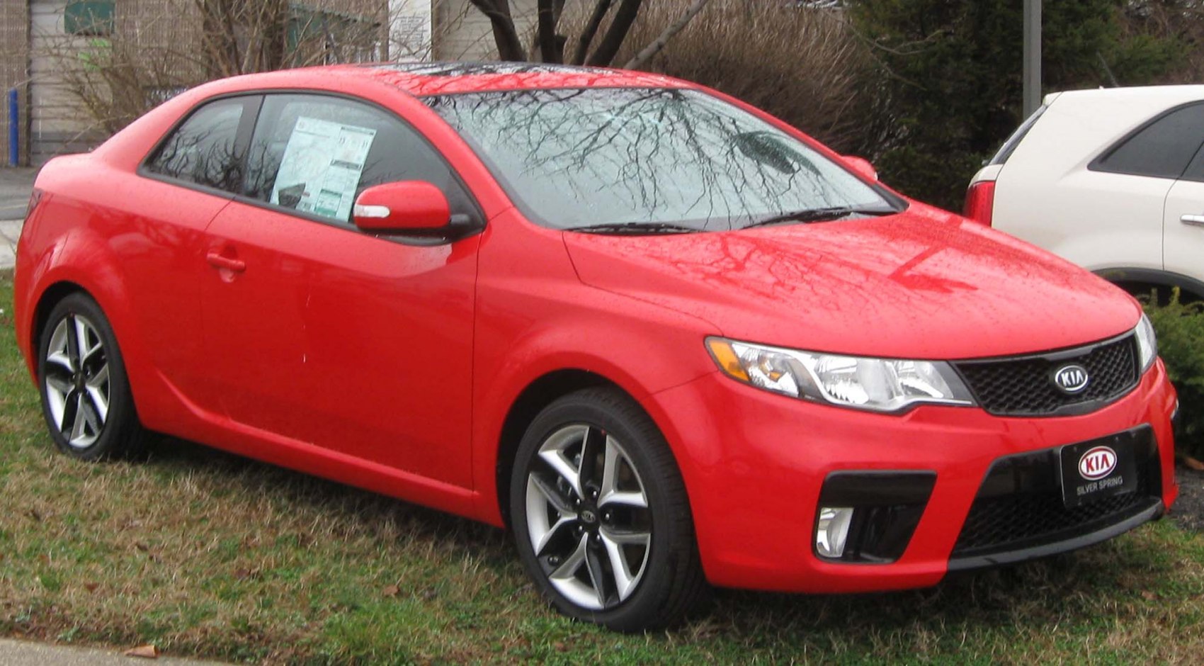 Red two-door coupe with alloy wheels and sleek design